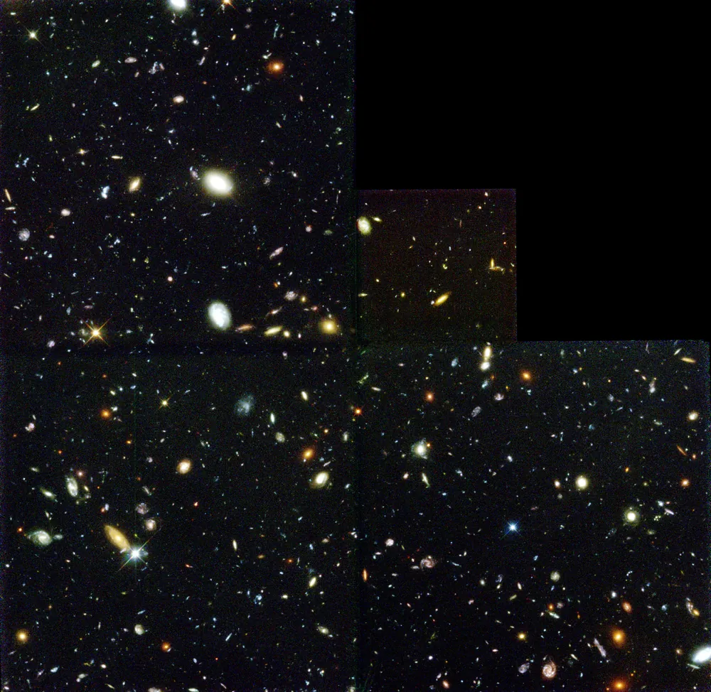 哈勃深空场全图，呈阶梯状，黑色背景上布满大小、颜色各异的星系